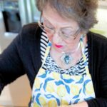 Woman baking and measuring ingredients.