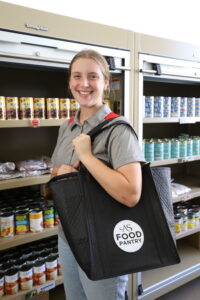Student holding food pantry bag