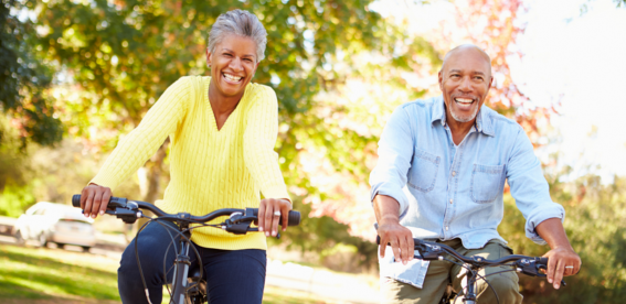 A couple riding bikes in their neighborhood