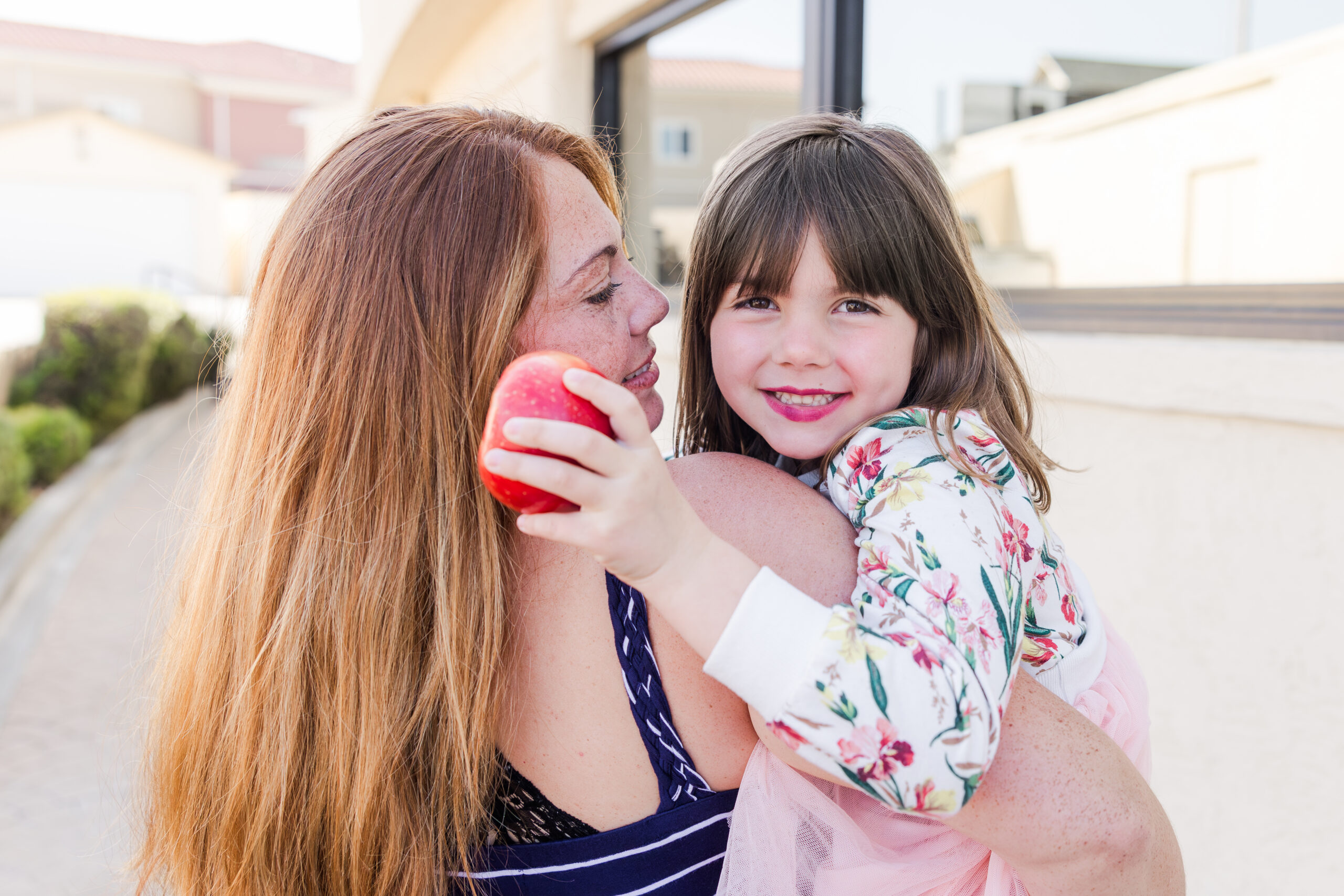 Mom and daughter with apple