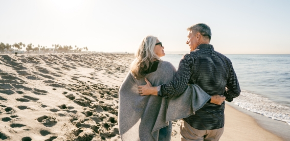 A couple walking on the beach.