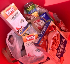 A red barrel filled with nonperishable food items.