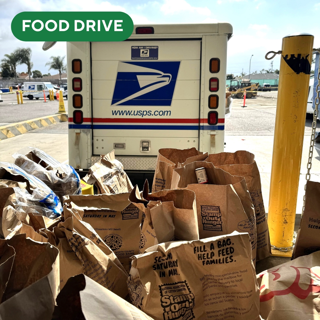 Stamp Out Hunger bags in front of a USPS truck.
