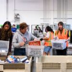 Volunteers sort incoming donations at the San Diego Food Bank warehouse during the 2026 Stamp Out Hunger Food Drive.