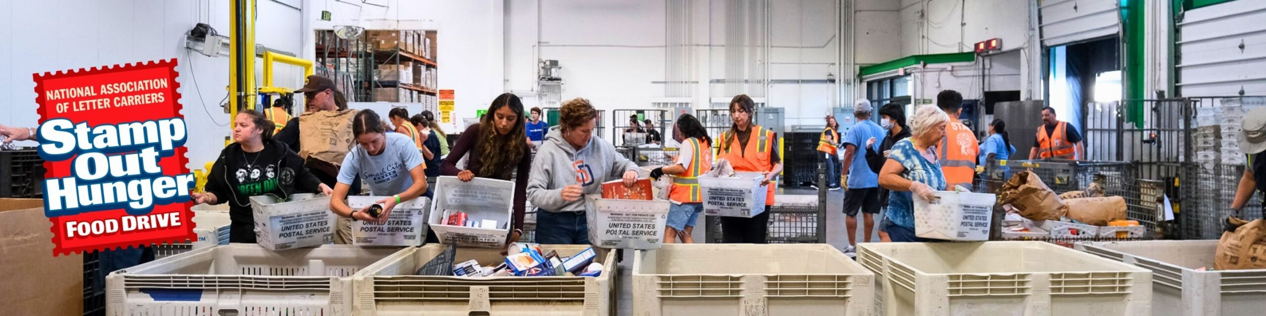 Volunteers sort incoming donations at the San Diego Food Bank warehouse during the 2026 Stamp Out Hunger Food Drive.